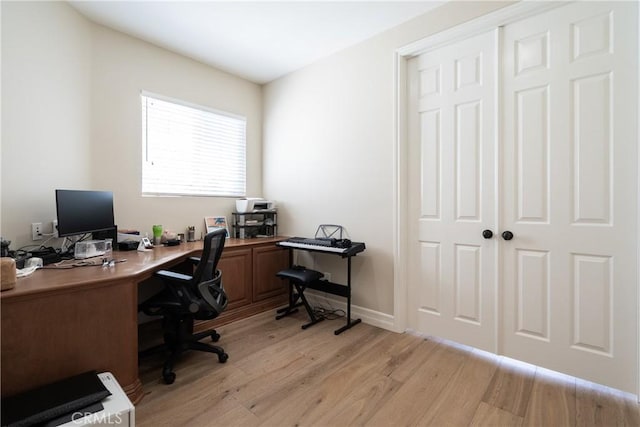 office featuring baseboards and light wood-style floors