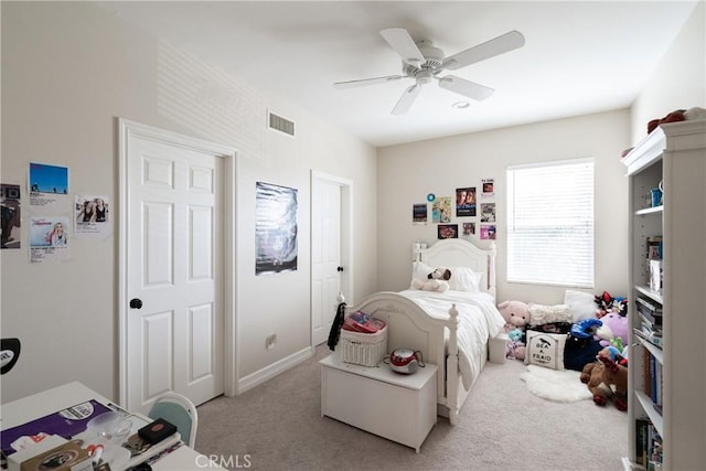 bedroom featuring light carpet, a ceiling fan, and visible vents
