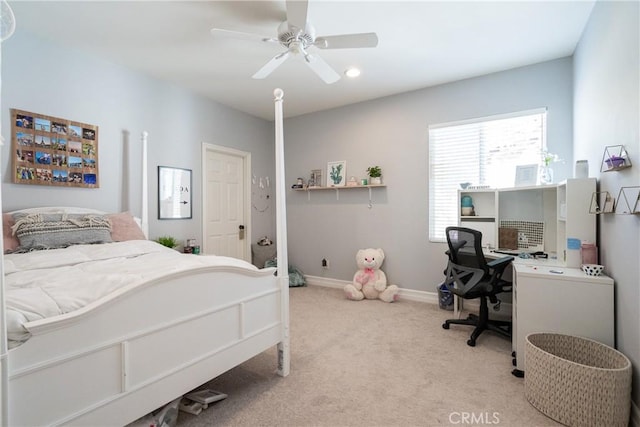 carpeted bedroom with baseboards and a ceiling fan