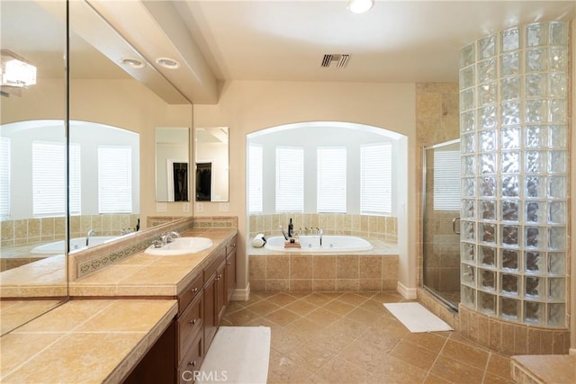 bathroom featuring a bath, a stall shower, visible vents, tile patterned flooring, and vanity