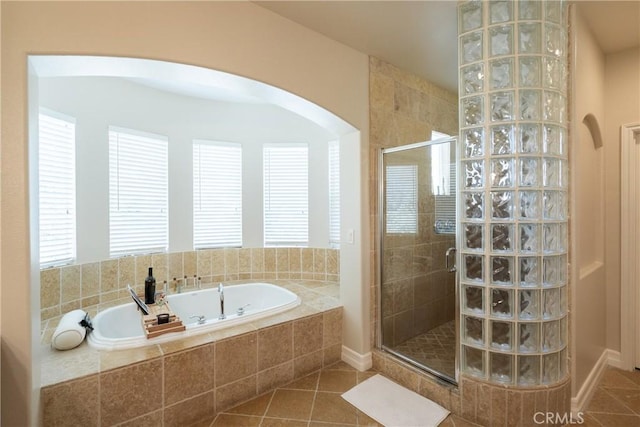 bathroom with a tile shower, a garden tub, tile patterned flooring, and a healthy amount of sunlight