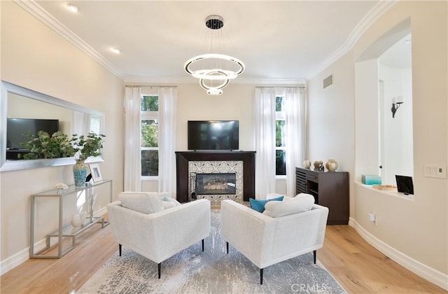 living room featuring a high end fireplace, visible vents, ornamental molding, and wood finished floors