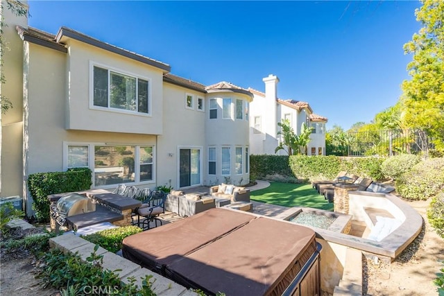 back of property with a patio area, a tile roof, stucco siding, and outdoor lounge area