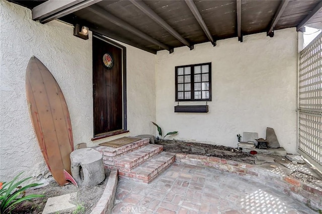 view of exterior entry with stucco siding