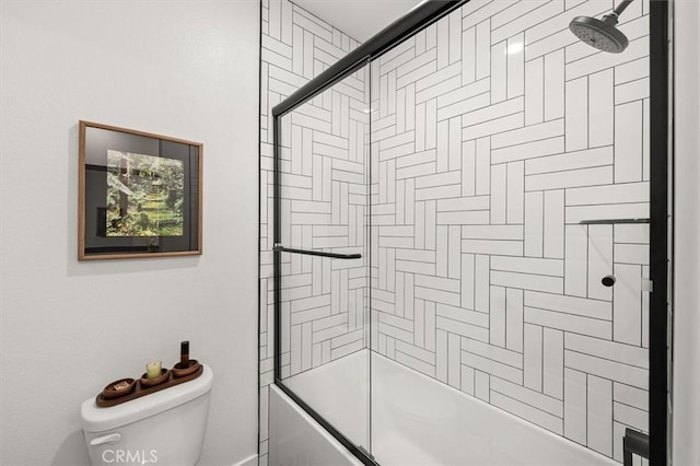 full bathroom featuring toilet and combined bath / shower with glass door