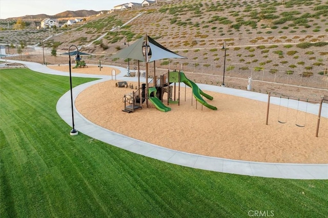 community playground featuring a yard and a mountain view