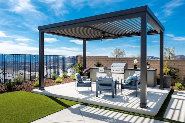 view of patio / terrace with a fenced backyard, a grill, outdoor lounge area, and an outdoor kitchen