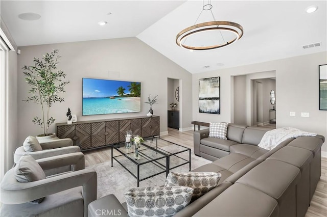 living room with lofted ceiling, light wood finished floors, baseboards, and visible vents