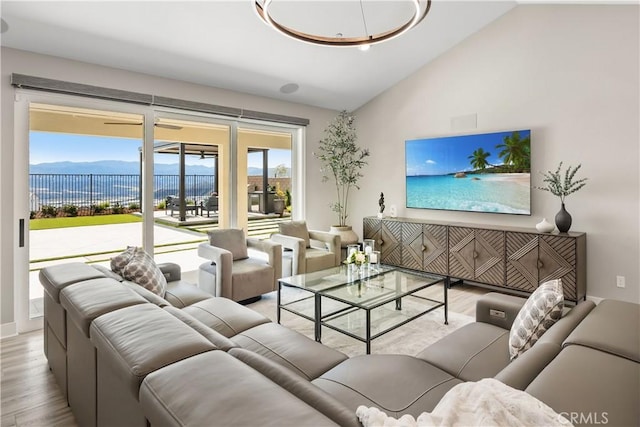 living room with lofted ceiling, a mountain view, and wood finished floors