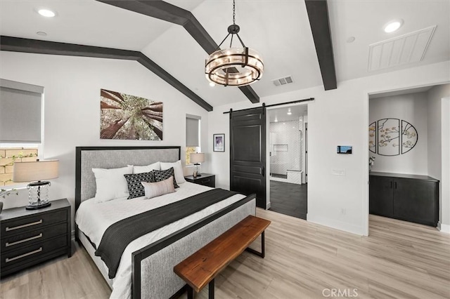 bedroom featuring visible vents, lofted ceiling with beams, light wood finished floors, and a barn door