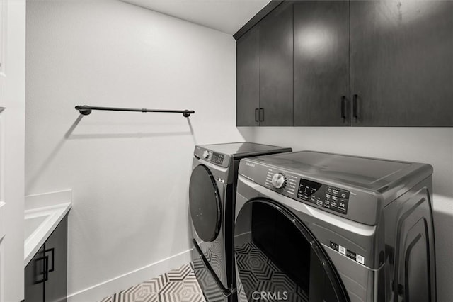 laundry room featuring cabinet space, independent washer and dryer, and baseboards