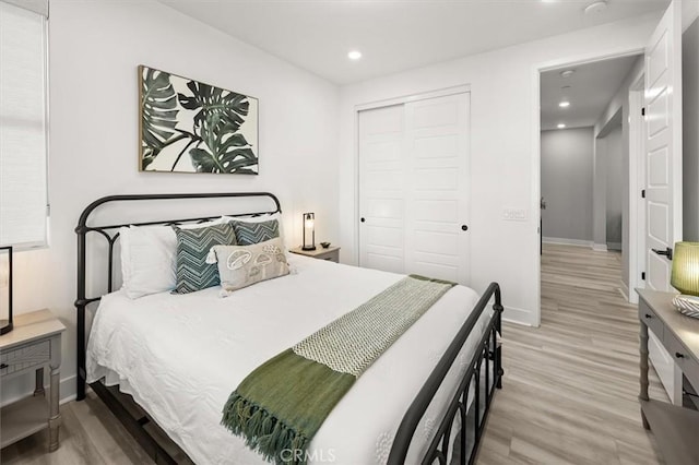 bedroom with recessed lighting, baseboards, a closet, and wood finished floors