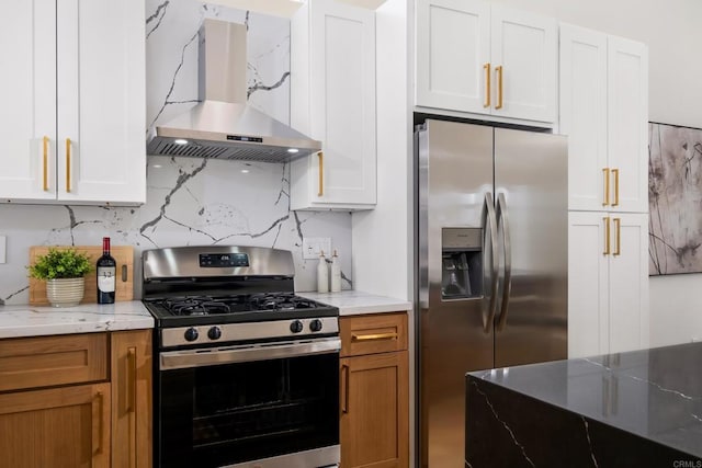 kitchen featuring stainless steel appliances, light stone counters, white cabinetry, and island range hood