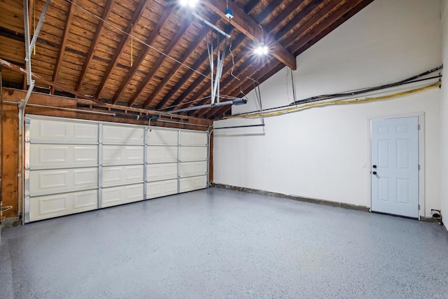 garage featuring wood ceiling and baseboards