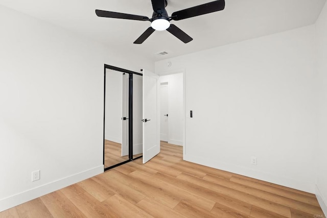 unfurnished bedroom with a closet, visible vents, light wood-style floors, ceiling fan, and baseboards