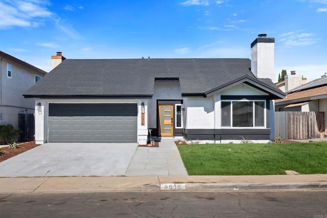 view of front of home with a garage, driveway, a chimney, fence, and a front yard