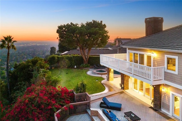 view of yard with an outdoor fire pit and a balcony