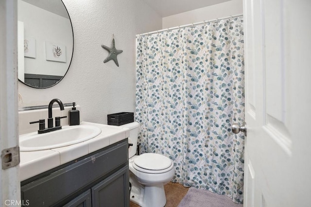 bathroom with vanity, toilet, and tile patterned floors