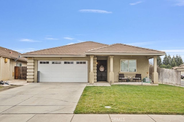 view of front of property featuring a garage, fence, concrete driveway, stucco siding, and a front yard