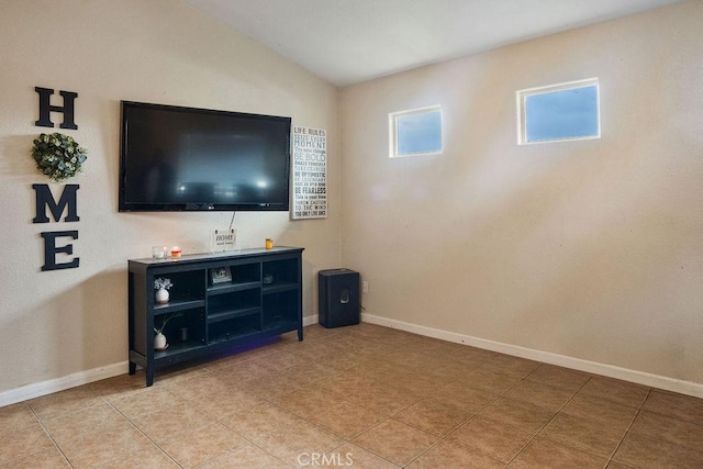 living area featuring lofted ceiling, baseboards, and light tile patterned floors