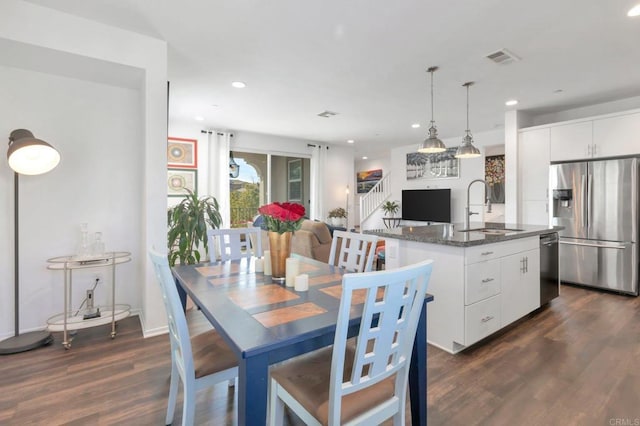 dining room featuring visible vents, dark wood-style flooring, and recessed lighting