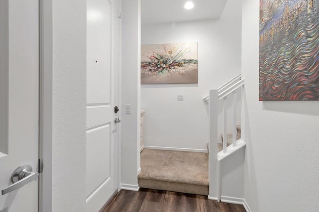 interior space with dark wood-type flooring, stairway, and baseboards