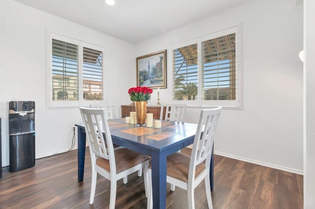 dining area with baseboards, dark wood-type flooring, and a wealth of natural light