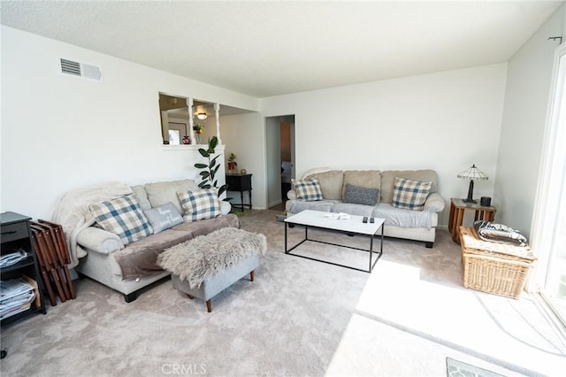 carpeted living area with visible vents