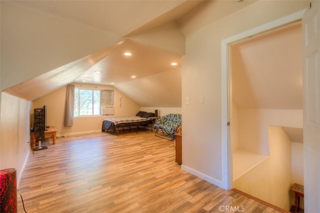 unfurnished bedroom featuring light wood-type flooring, baseboards, vaulted ceiling, and recessed lighting