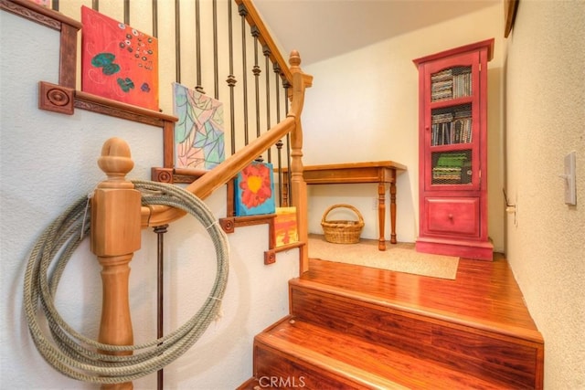 staircase featuring a textured wall