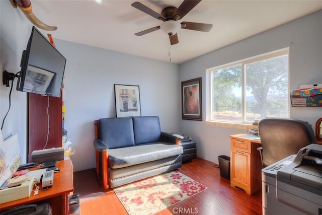 home office featuring dark wood finished floors and a ceiling fan