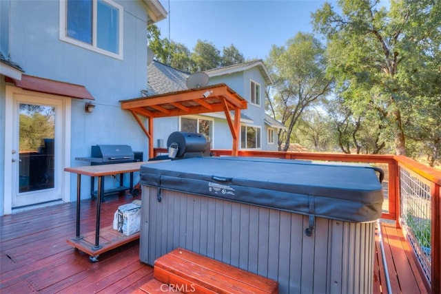 deck with a hot tub and grilling area