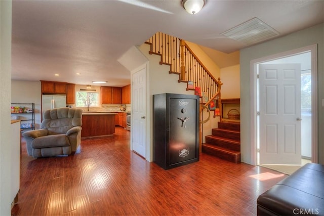 interior space featuring stairs, visible vents, and dark wood-style flooring