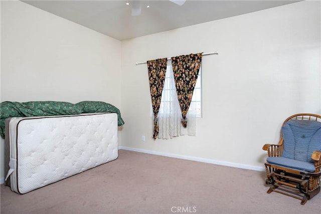 sitting room featuring carpet flooring, a ceiling fan, and baseboards