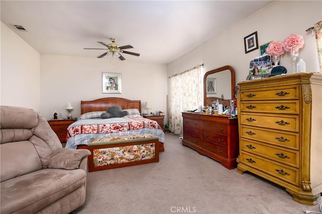 bedroom featuring light carpet, visible vents, and a ceiling fan