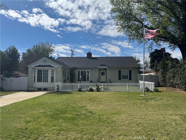 view of front of property featuring a front lawn, a fenced front yard, and a chimney