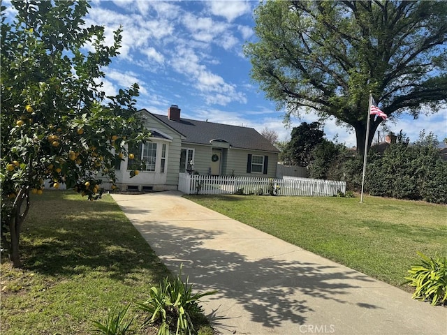 view of front of home with a fenced front yard, a chimney, roof with shingles, and a front yard