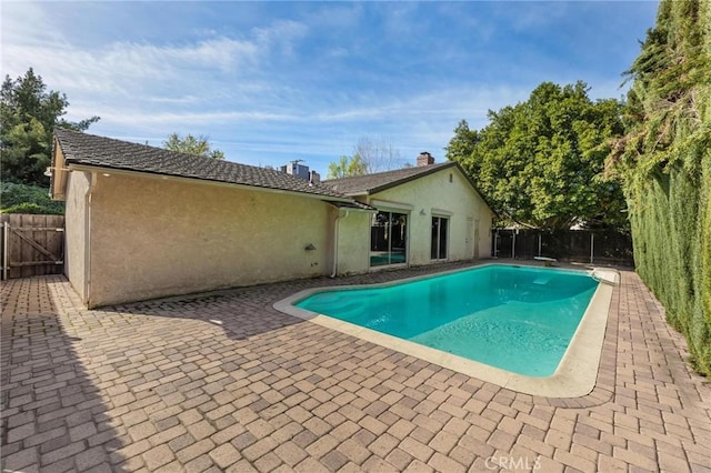 view of pool with fence, a fenced in pool, and a patio