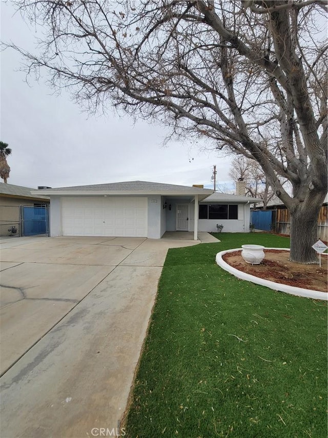 ranch-style home with an attached garage, fence, driveway, stucco siding, and a front lawn