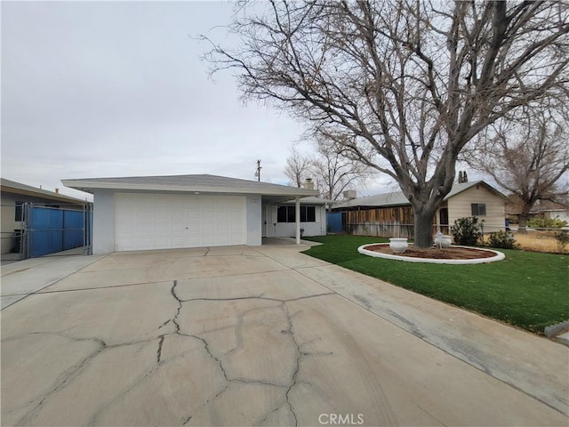 view of front of house with stucco siding, concrete driveway, a front yard, fence, and a garage