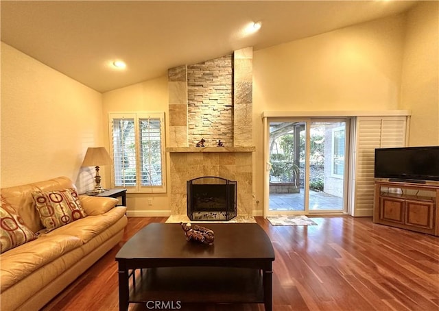 living room featuring recessed lighting, a fireplace, a wealth of natural light, and wood finished floors