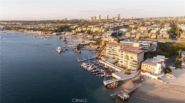 birds eye view of property with a view of city and a water view