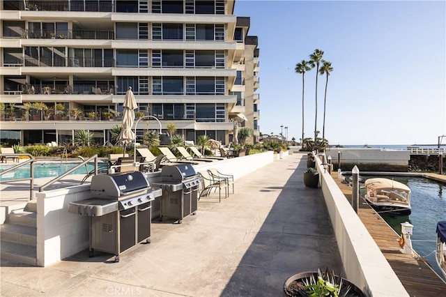 view of property's community featuring a water view and a patio