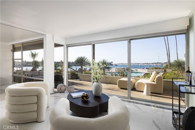 sunroom / solarium featuring a water view and a healthy amount of sunlight