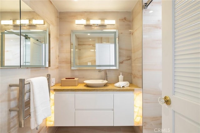 bathroom with tile walls and vanity