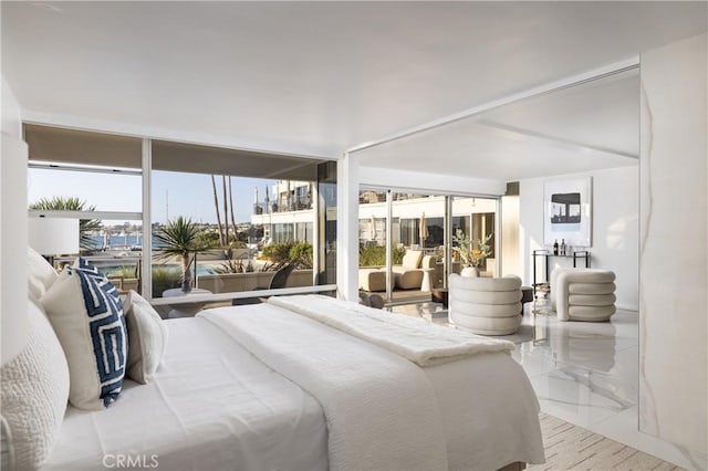 bedroom with marble finish floor and multiple windows