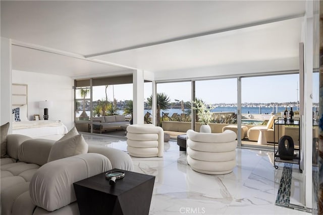 living room with a water view and marble finish floor