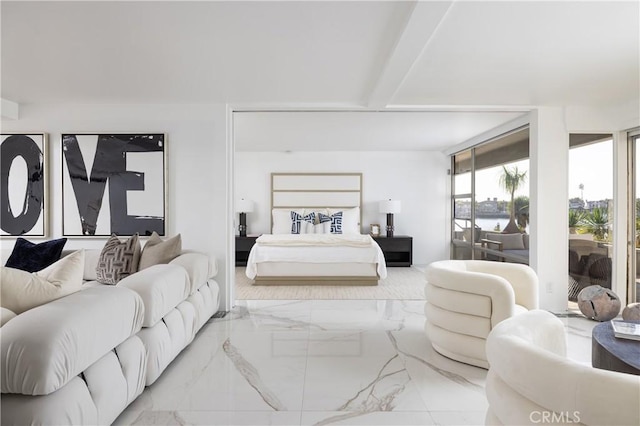 bedroom with beam ceiling, access to outside, and marble finish floor