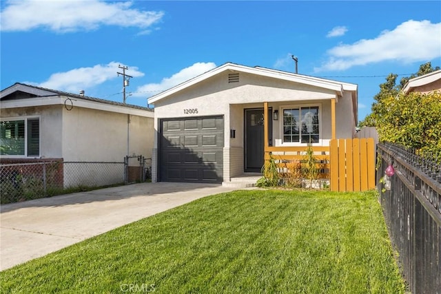 view of front facade with a garage, fence, driveway, stucco siding, and a front lawn