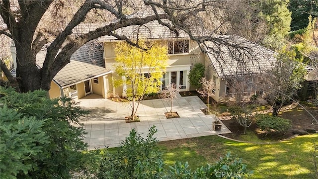 exterior space with a yard, a patio, and stucco siding